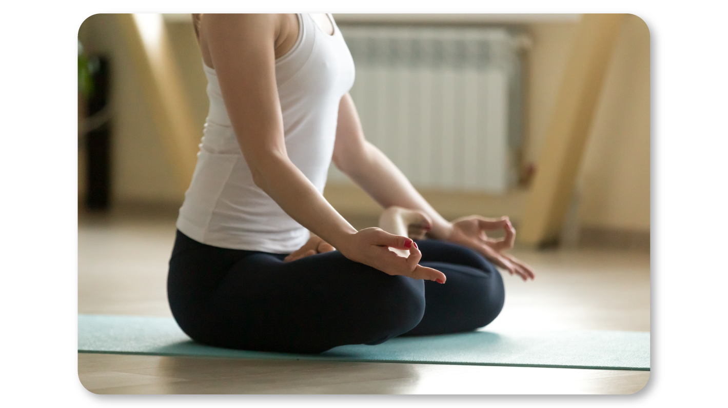 An Employee Practices Self Care At Work by Practicing Meditation