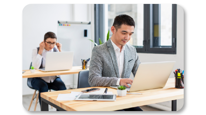 Employees working happily due to benefits of yoga in workplace