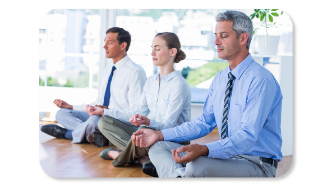 Corporate Employees are seen practicing mindfulness activity under employee wellness programs